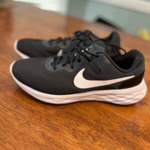 Like Brand New Men’s Nike Revolution black white shoes size 9.